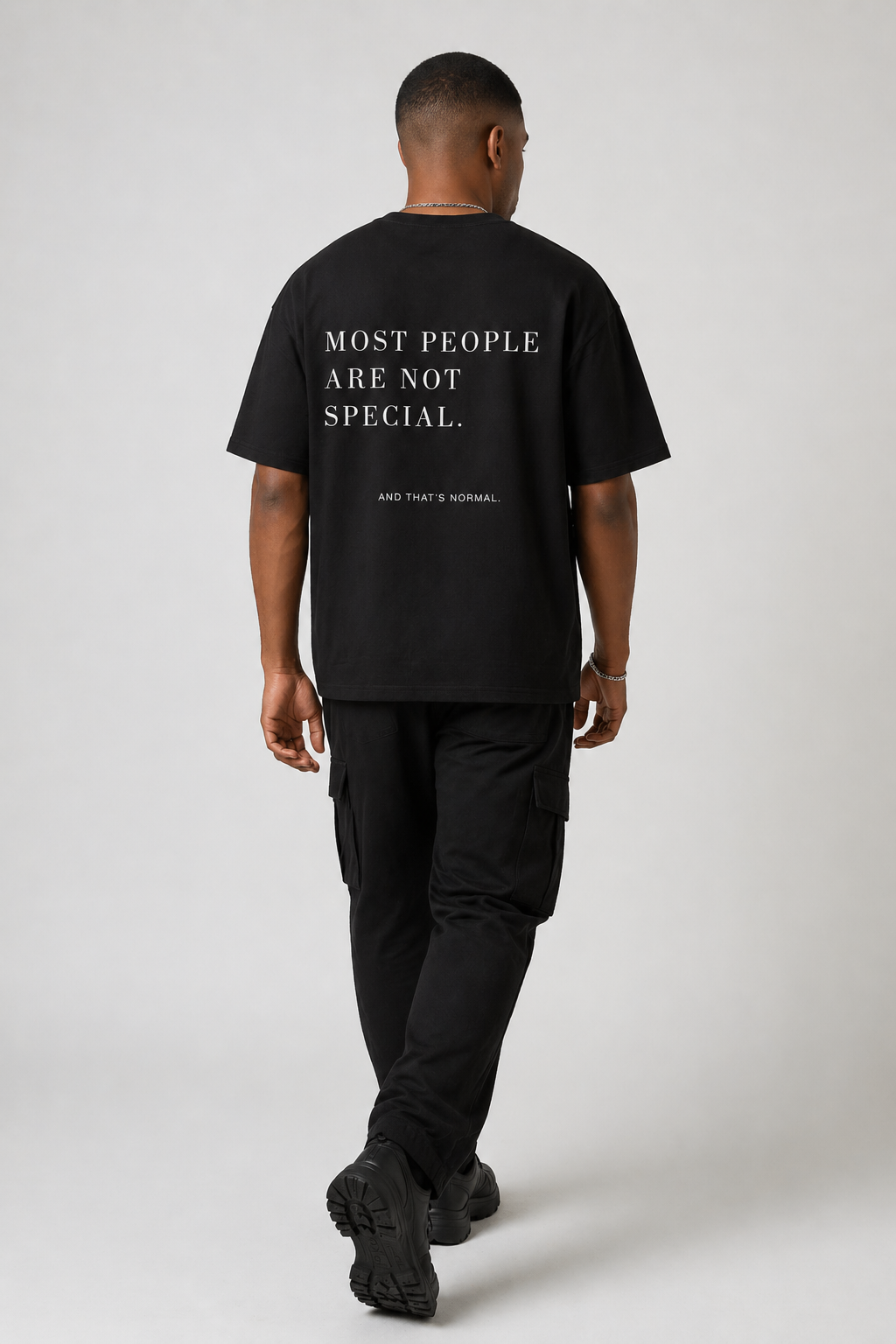 Model from behind wearing the Most People Are Not Special black heavyweight shirt